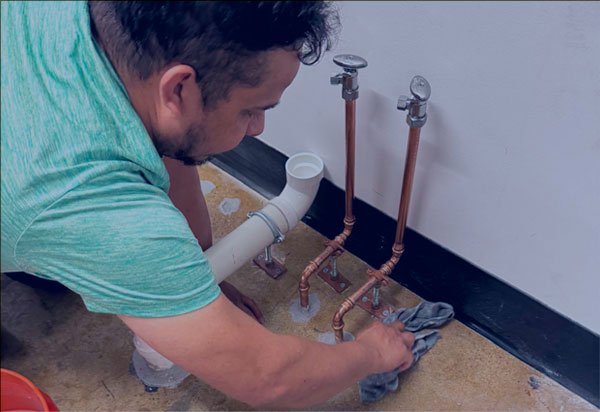 Licensed plumber from DMV Crystal Plumbing LLC installing copper water lines and rough-in plumbing for luxury bathtub in the DMV area